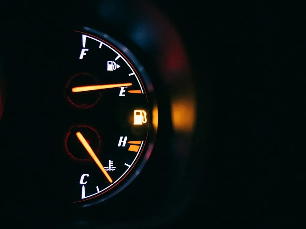 A fuel gauge glowing on a dark dashboard